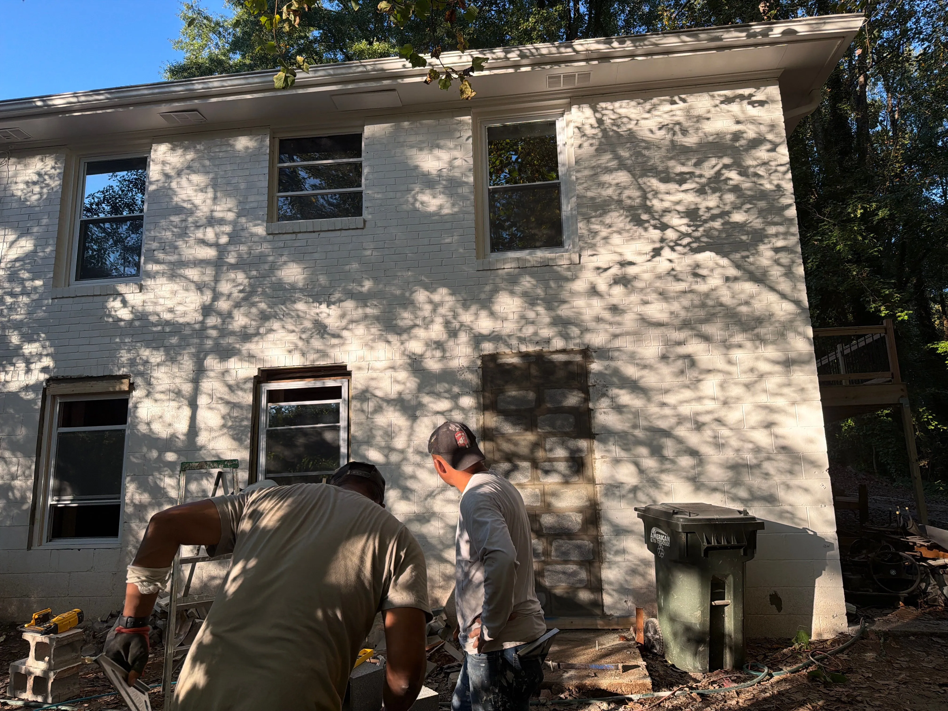3356 Woodview Dr SE, Smyrna — Crew working at the rear exterior