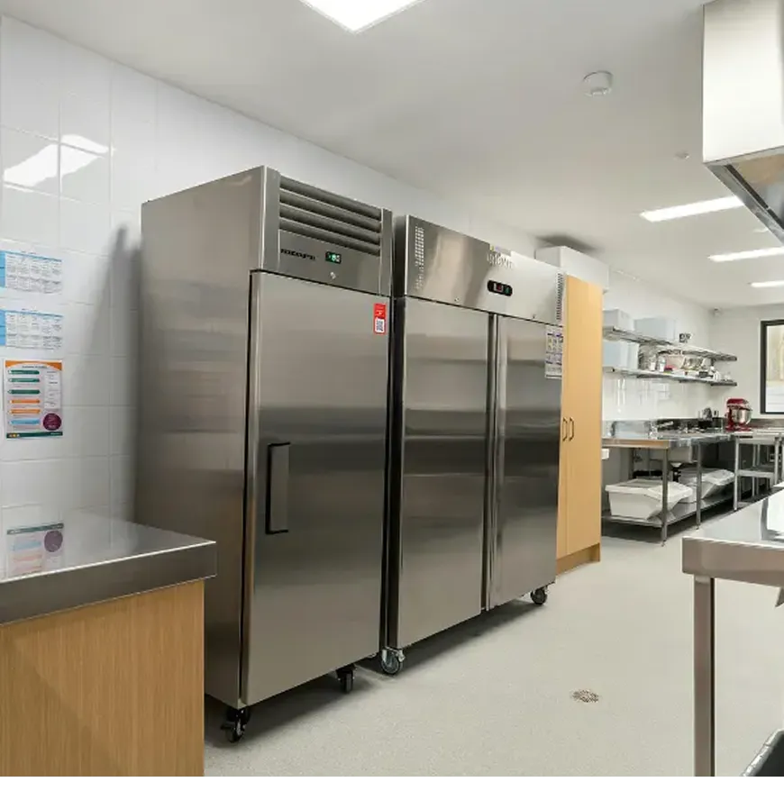 Commercial kitchen with two large stainless steel refrigerators