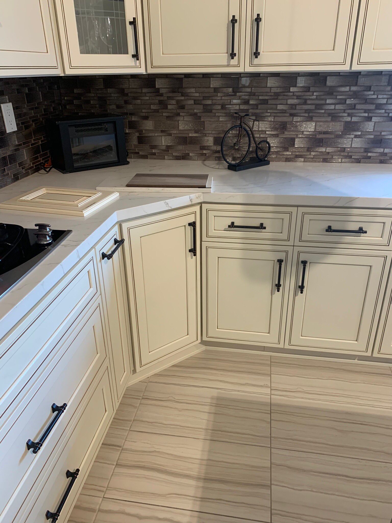 Modern kitchen with white cabinetry and marble countertops