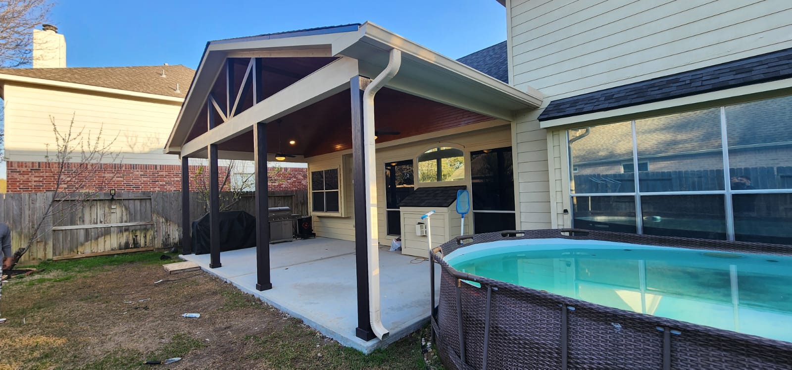 Backyard with freshly installed pergola and pool area.
