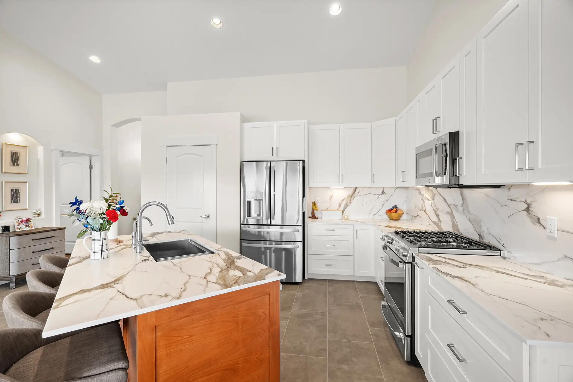 Beautifully remodeled kitchen with white marble countertops and white shaker cabinets in St. George, UT