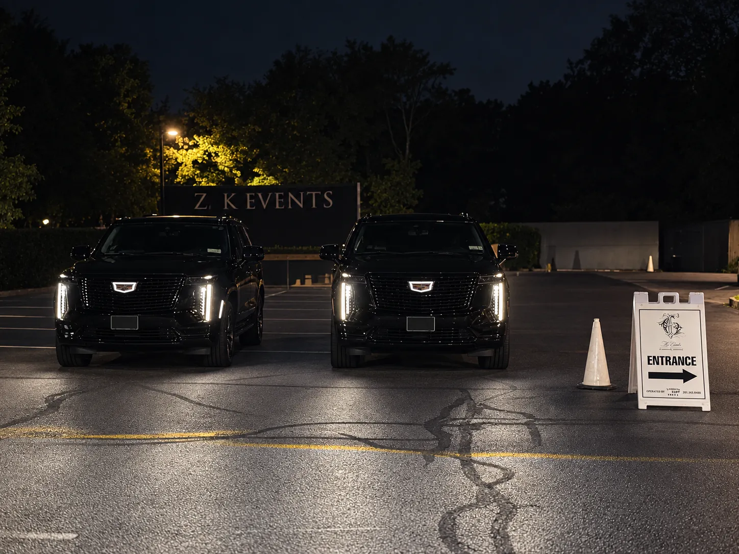 Two GeronimoLux Cadillac Escalade ESVs staged for an event pickup at night