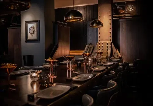 The elegant dining room at The New York Restaurant, featuring stylish decor and a warm ambiance.