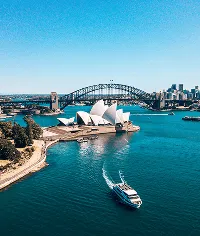 Sydney Opera House, Harbour Bridge and ferry on Sydney Harbour, NSW, Australia. Iconic landmark view.