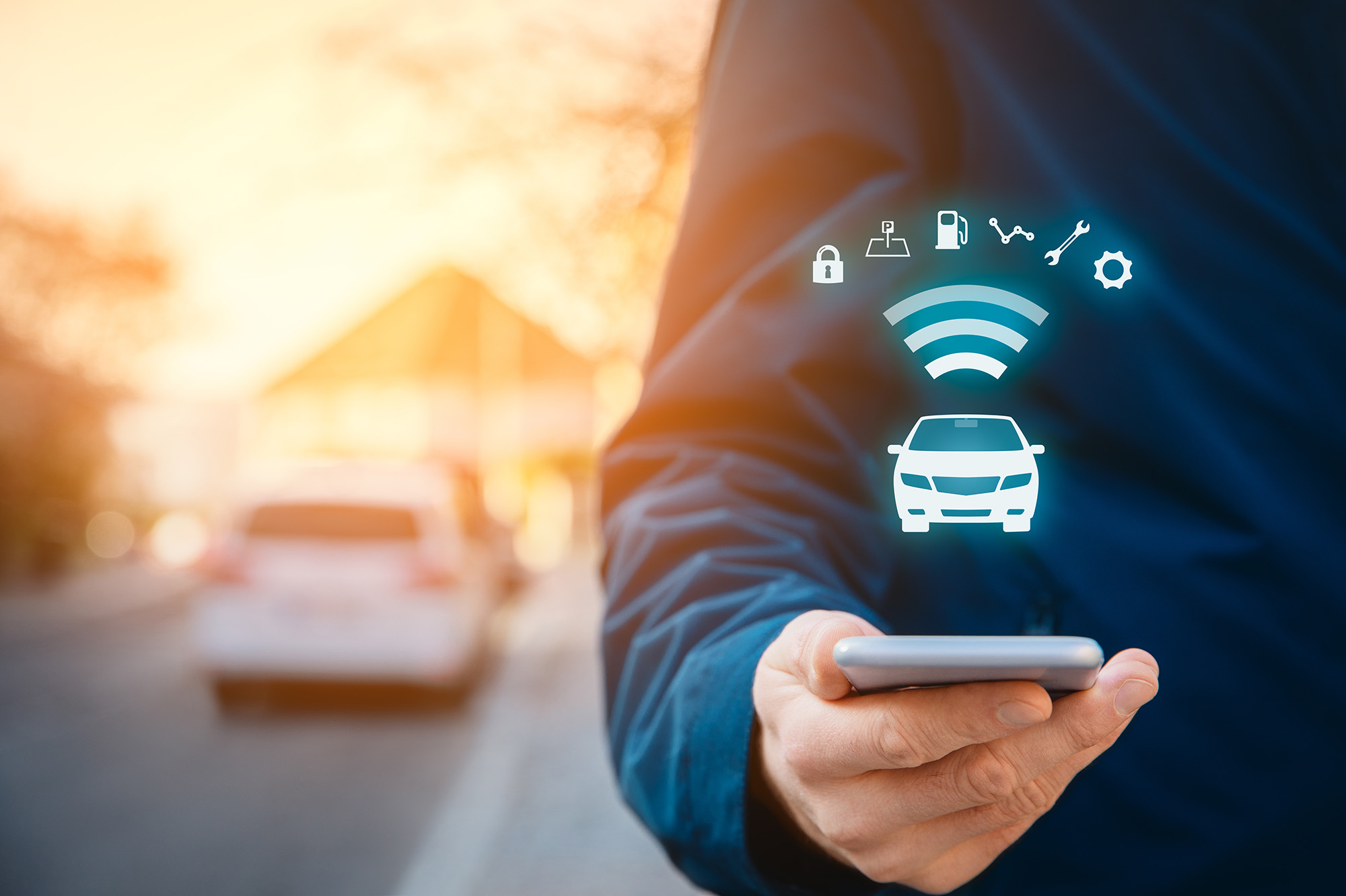 Person holding a smartphone with digital icons of a car and wireless signals representing car connectivity features.