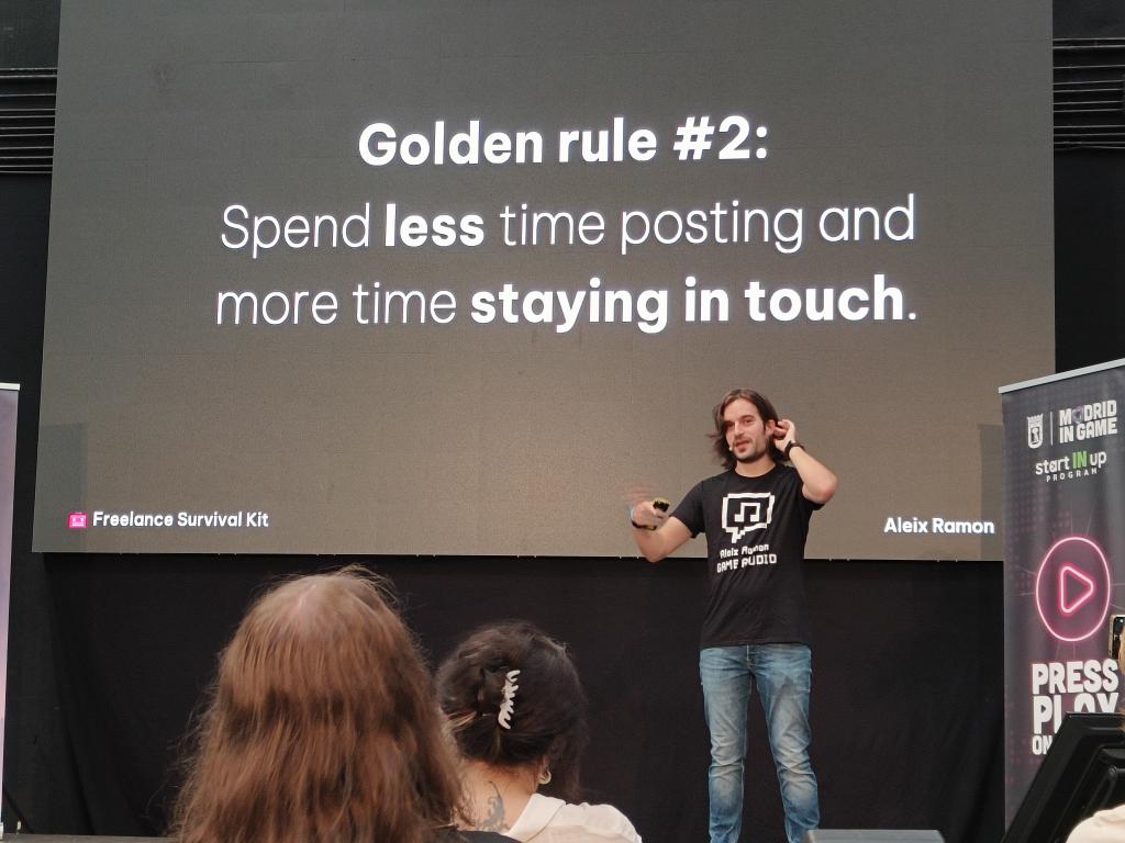 Aleix Ramon giving a presentation with a slide that reads: Golden rule #2: Spend less time posting and more time staying in touch.