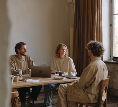 Three architects in conversation, reflecting collaborative design thinking and expert architectural planning.
