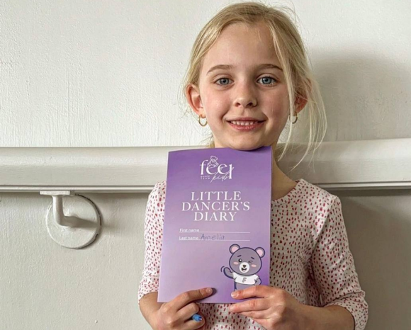 the child is holding a certificate