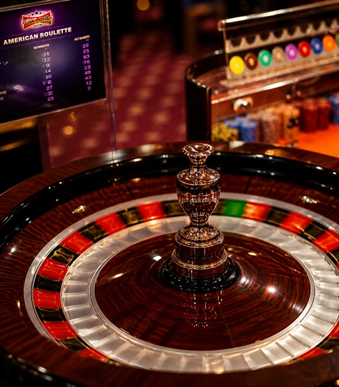 Close-up of a spinning roulette wheel in a casino with colored numbered slots.