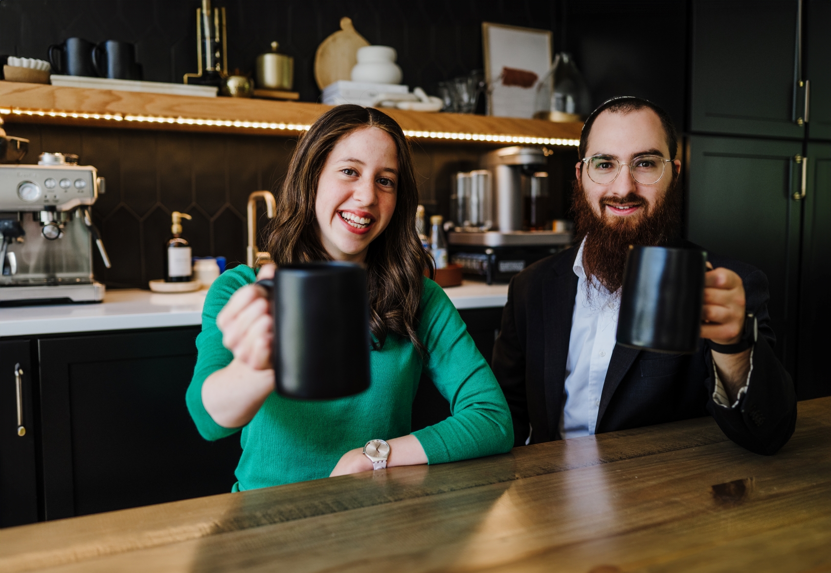Shmulie & Mushky Munitz, co-founders of Munitz & Co., discussing financial intelligence services over coffee, helping businesses make data-driven decisions for growth and success.