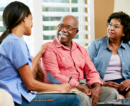 a group of people sitting on a couch talking to each other