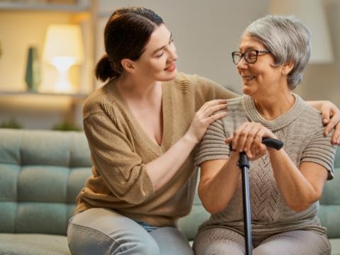 A woman smiling to an elderly woman
