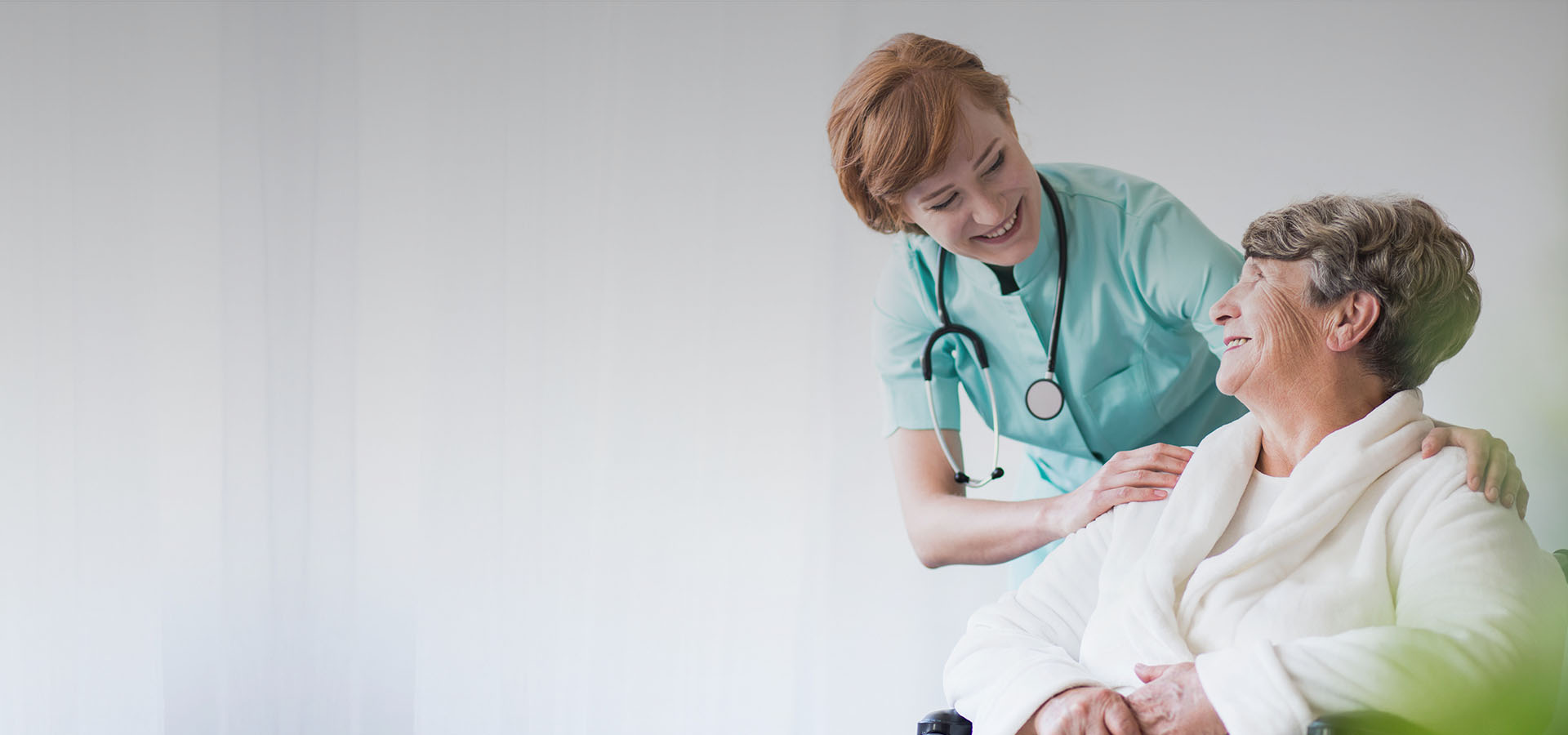 a woman in a wheelchair being assisted by a nurse