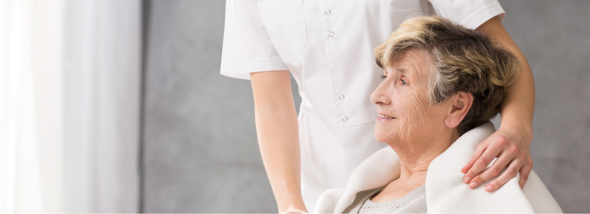 a woman getting her hair brushed by a woman in a white shirt