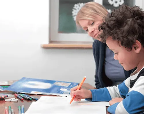 a woman sitting at a table with a child