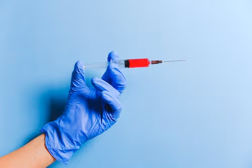 Free Person Holding Syringe Stock Photo