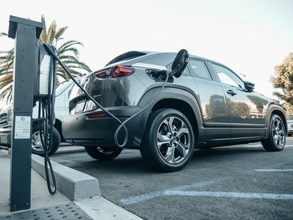 Free Gray Electric Car Parked on a Charging Bay Stock Photo
