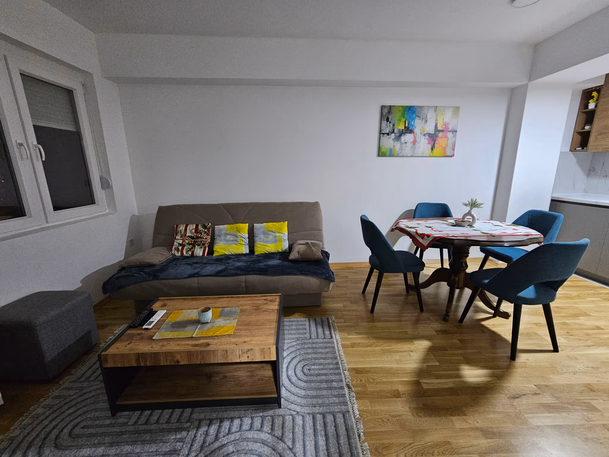 Spacious living room with seating area in ST Central Home apartment in Skopje