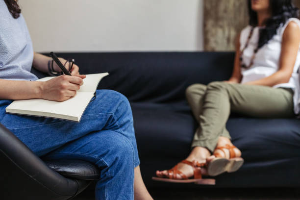 Psychotherapy session, woman talking to his psychologist in the studio stock photo