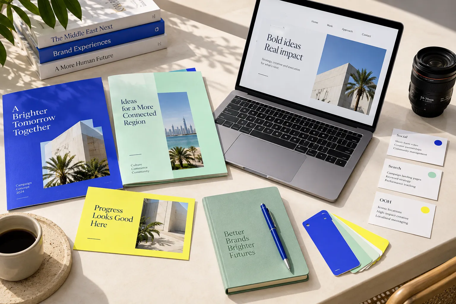 Conceptual service visual: Campaign creative, landing-page planning and channel materials arranged on a studio table.