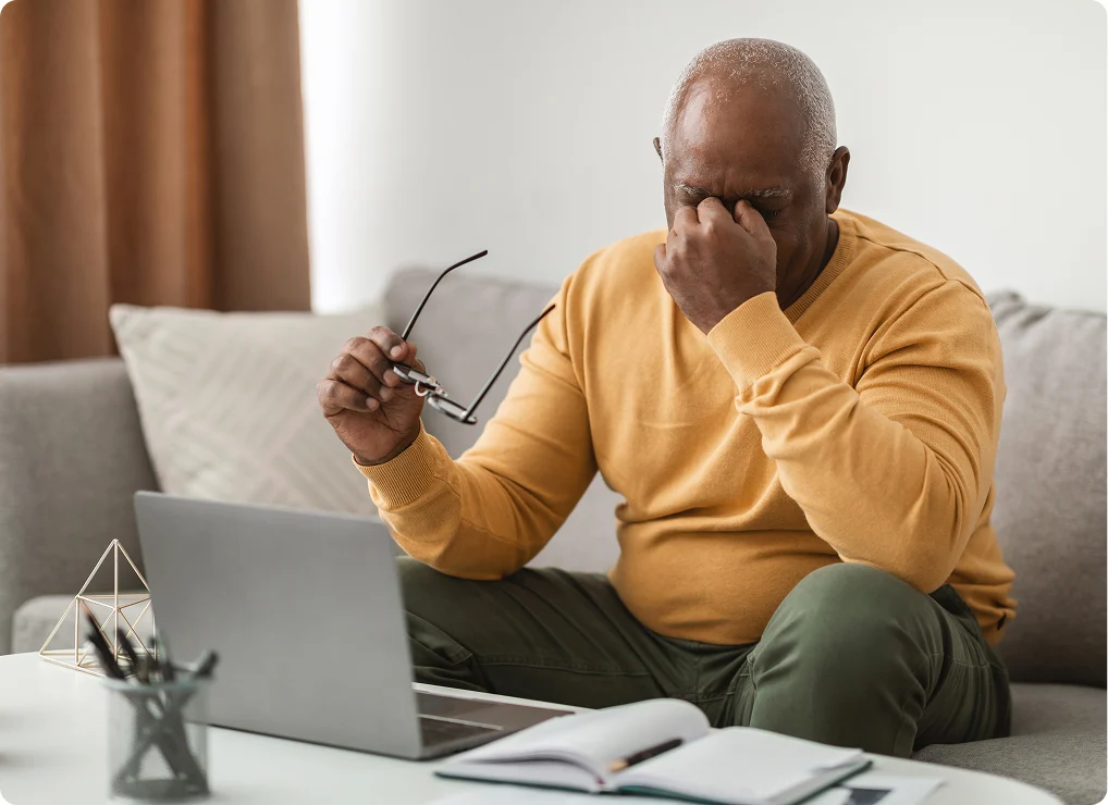 Middle-aged woman with glasses looking at a tablet, with flying birds and floating file folders illustrations behind her on a blue background.