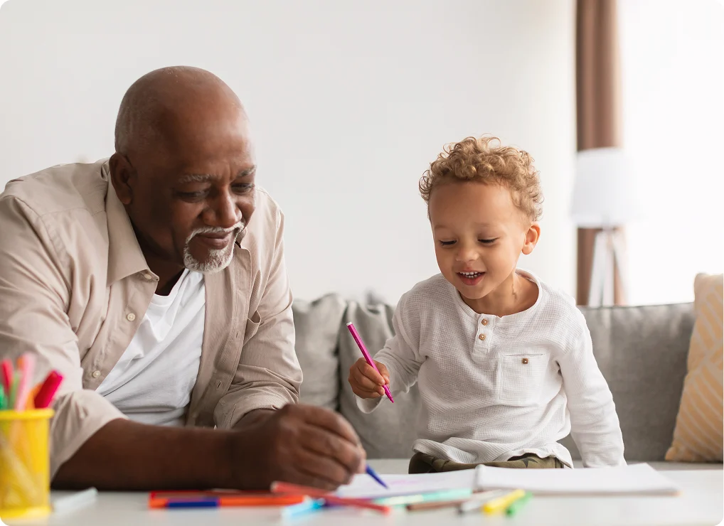 Elderly person in a light blue shirt organizing manila folders in a metal filing box against a blue background with small illustrated plant and folder icons.