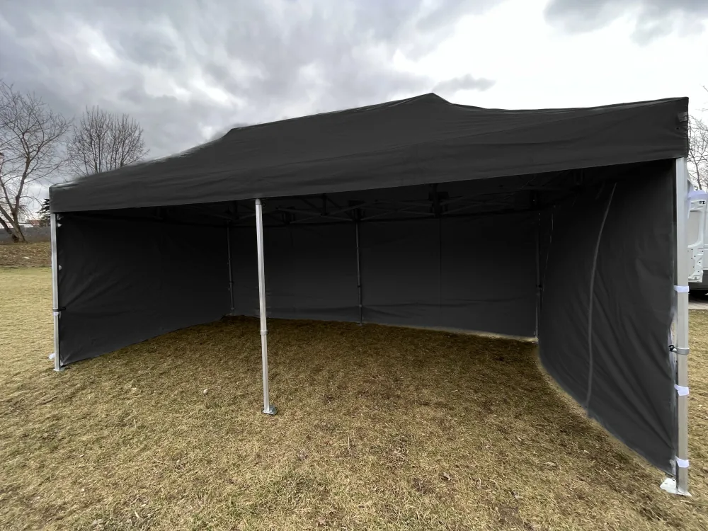 Nůžkový stan 8x4 m černý s otevřenou přední stranou a bočními stěnami na trávníku