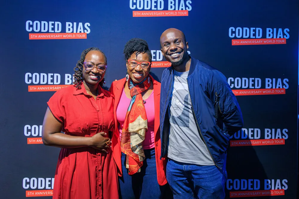 Guests in front of Coded Bias backdrop
