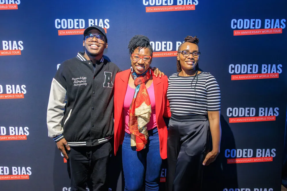 Guests in front of Coded Bias backdrop