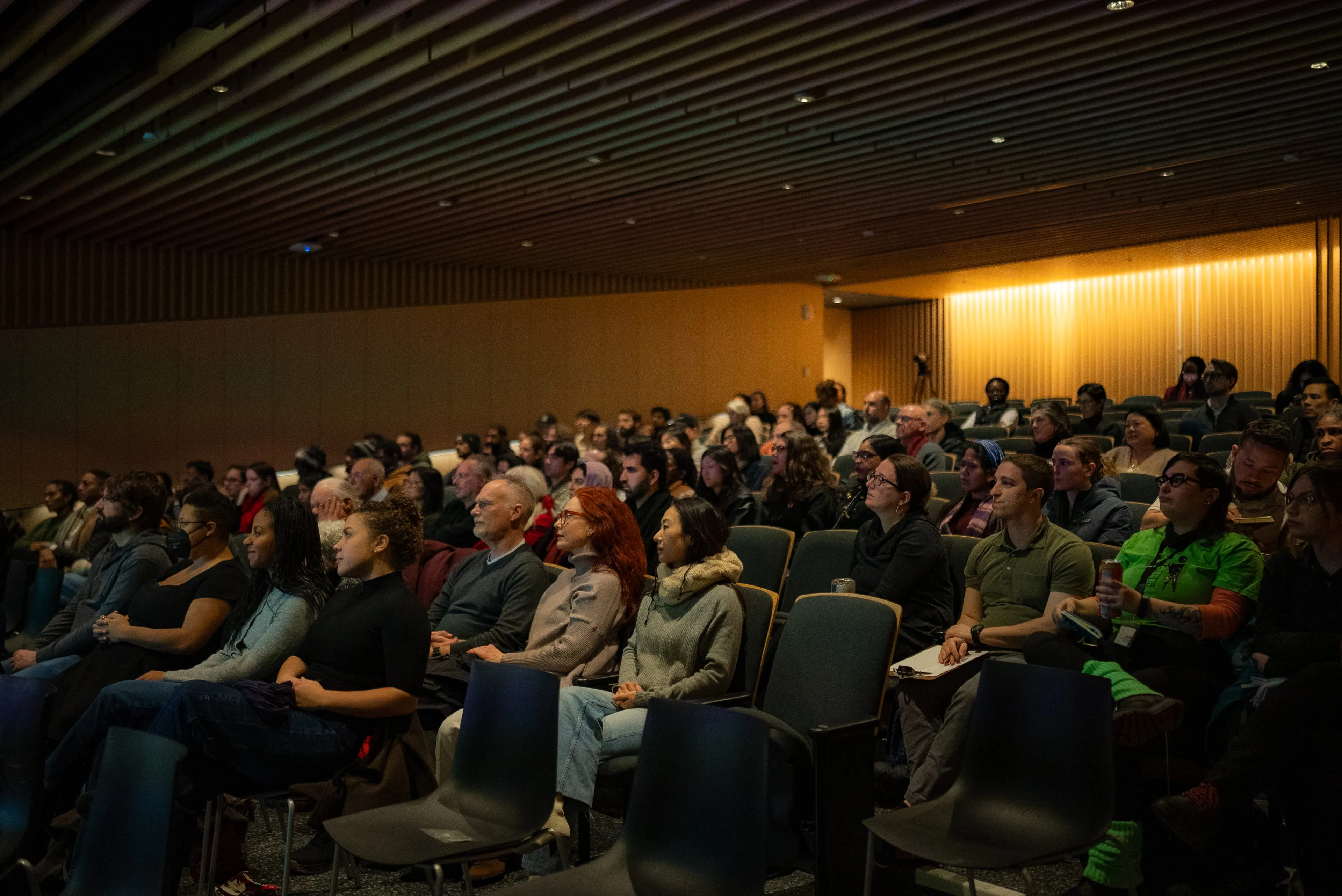 Full auditorium of audience members watching Coded Bias