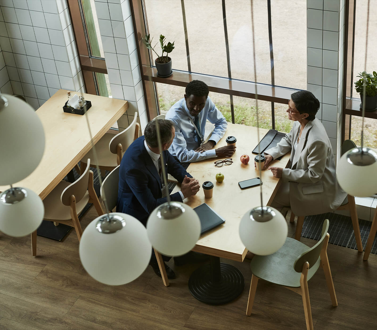Business management team discussing finances at cafe