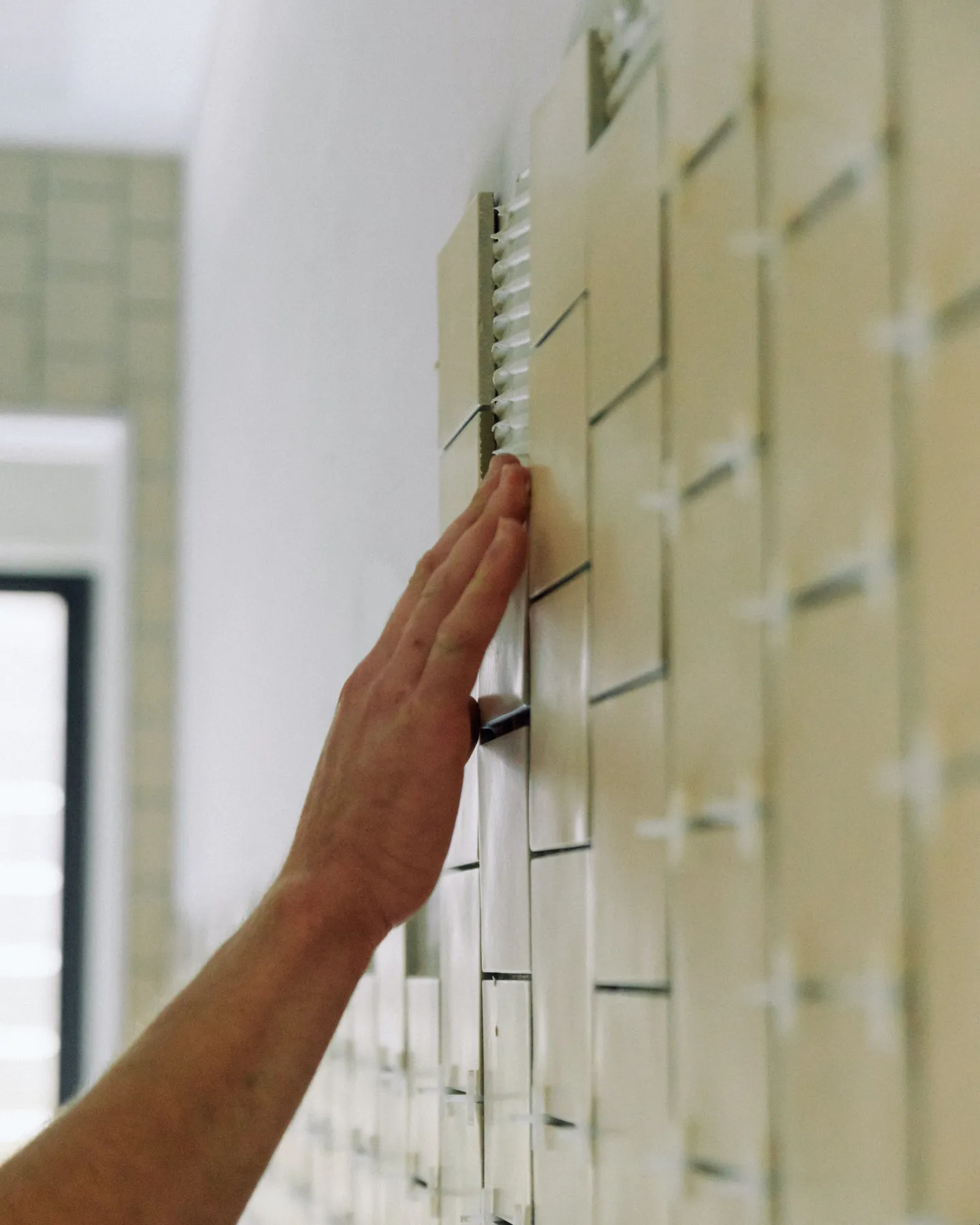 Professional tiler installing premium wall tiles in a custom home project in Toowoomba.
