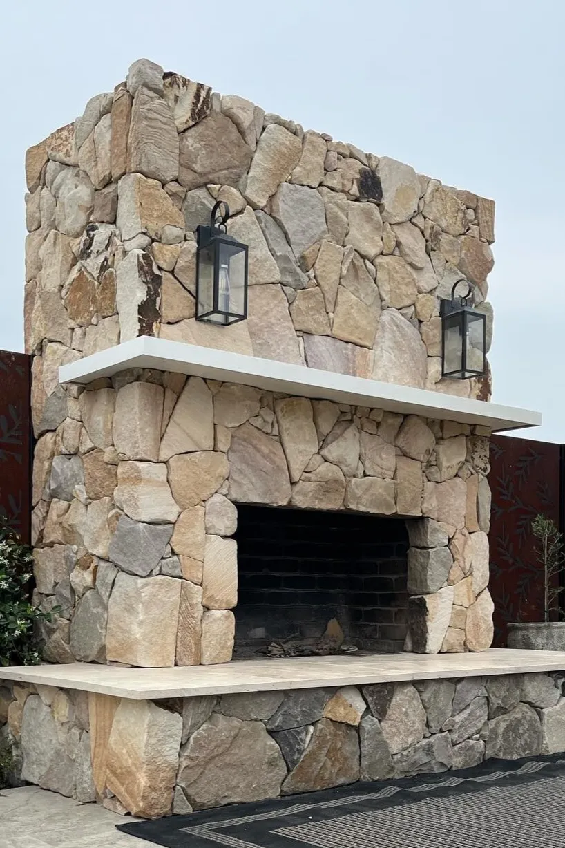 Custom natural stone fireplace installation showcasing expert stone masonry for a luxury home in Toowoomba.