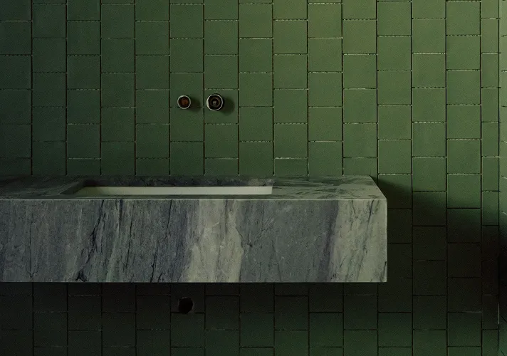 Bespoke green tile feature wall creating a unique and contemporary interior design statement.