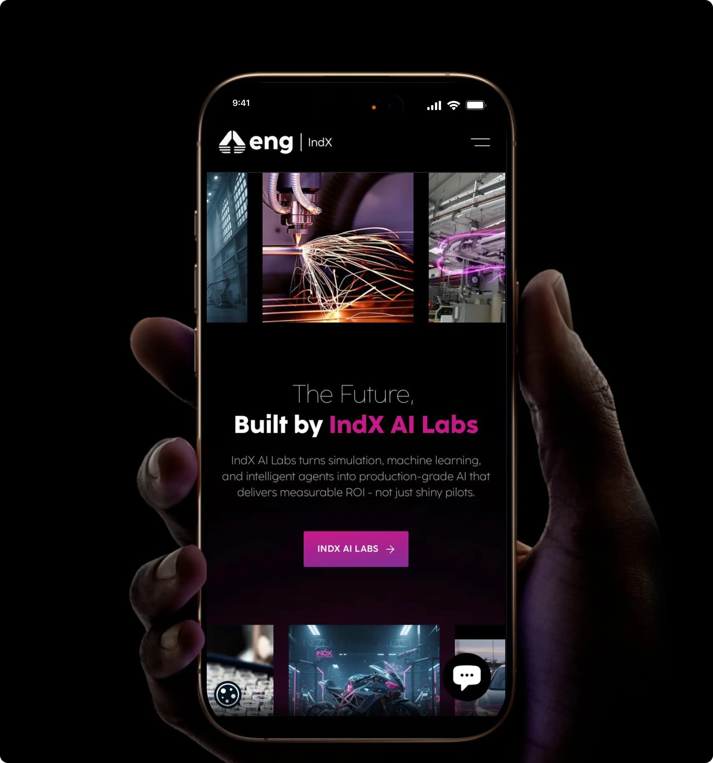 Hand holding a smartphone displaying IndX AI Labs website showcasing AI for manufacturing with images of machinery and a purple call-to-action button.