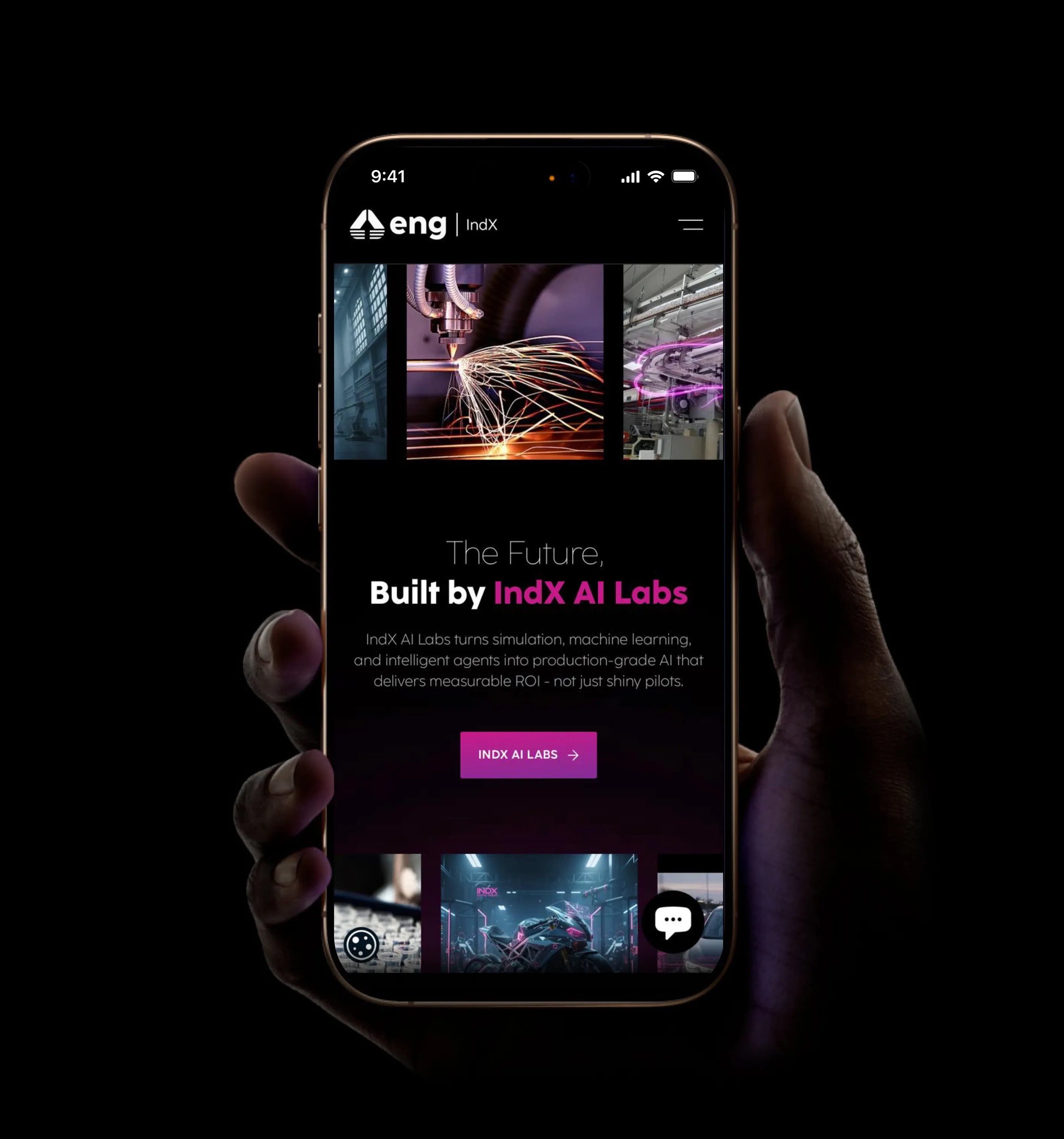 A hand holding a smartphone displaying the IndX AI Labs mobile interface, featuring industrial imagery and bold pink typography against a dark theme.