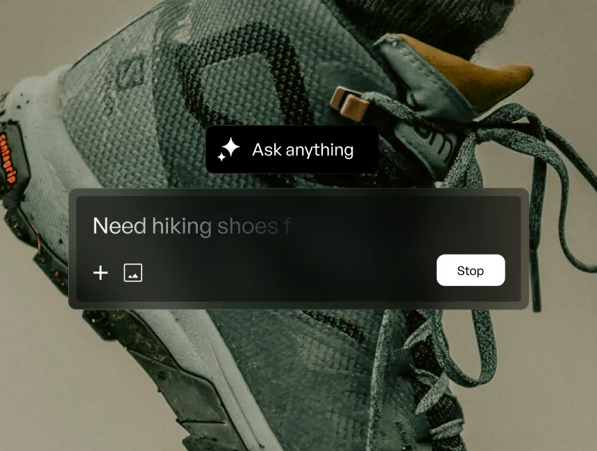 Close-up of a gray hiking shoe with laces and textured sole on a neutral background.