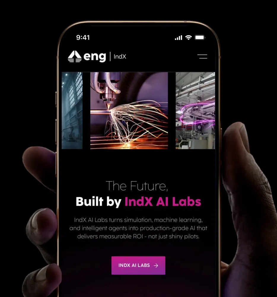 Hand holding phone displaying IndX AI Labs site about AI-driven simulation and machine learning solutions.