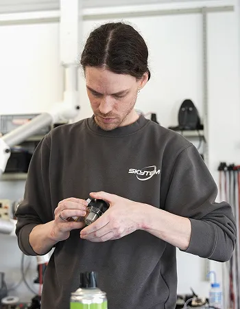 SkyTEM technician assembling an electronic component