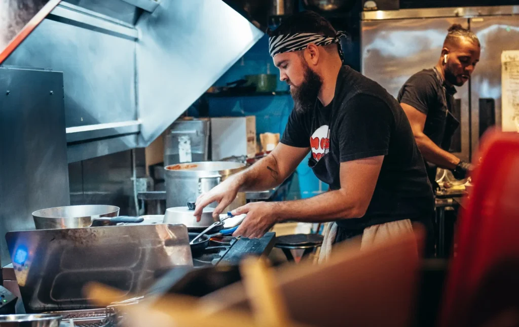 Two chefs working in a kitchen preparing food