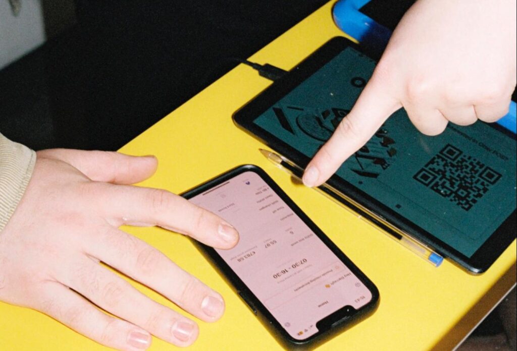 Trainer showing a restaurant manager how to create staff schedules in Nory