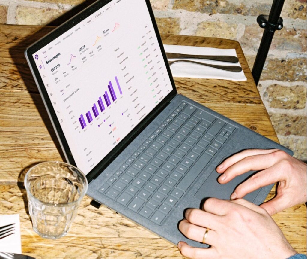 Restaurant owners using Nory's sales insights on a laptop