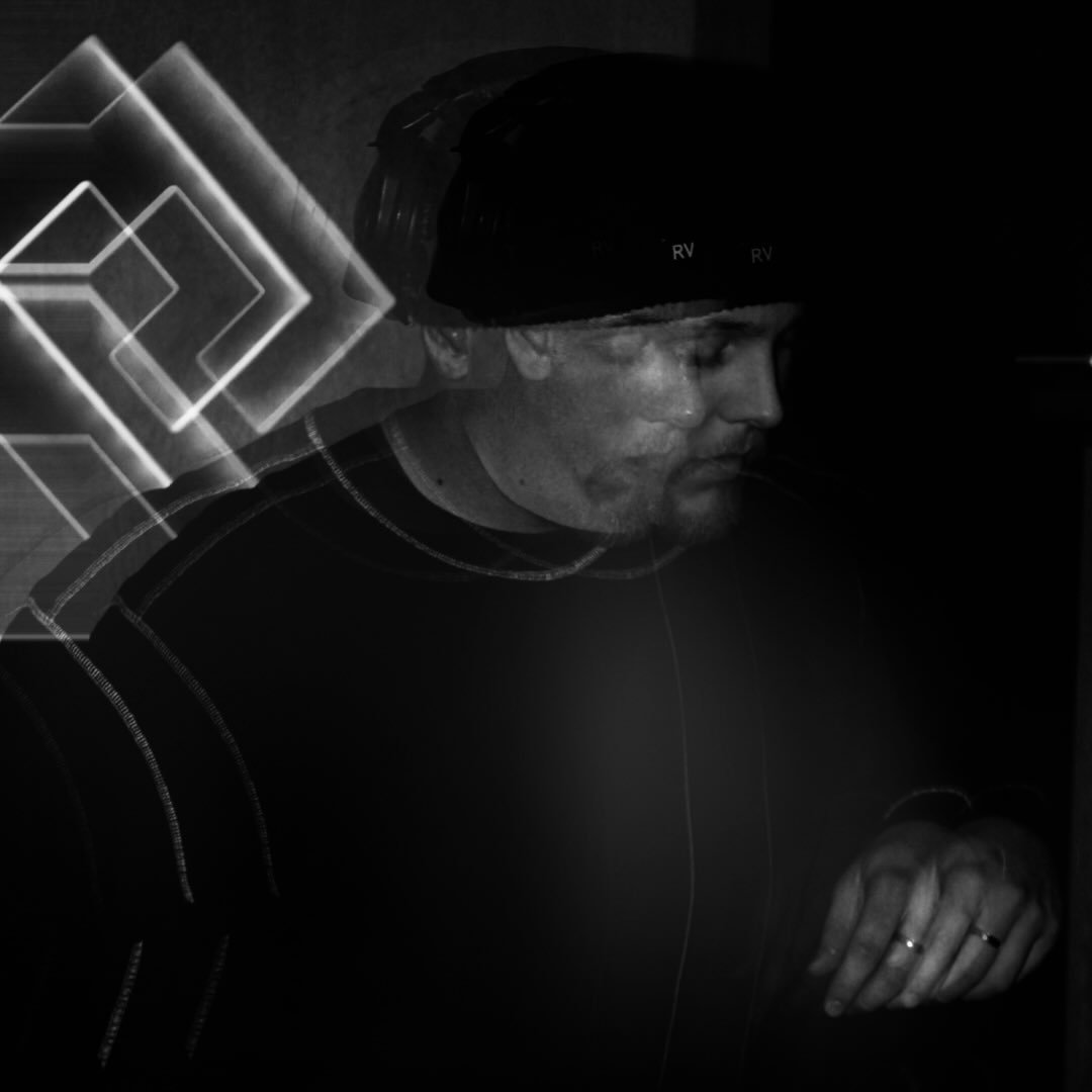 Black and white photo of a man with a beanie and rings, shown with a double-exposure effect and geometric light patterns behind him.