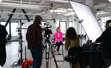 STMNT Studios crew filming an interview with professional lighting and camera setup