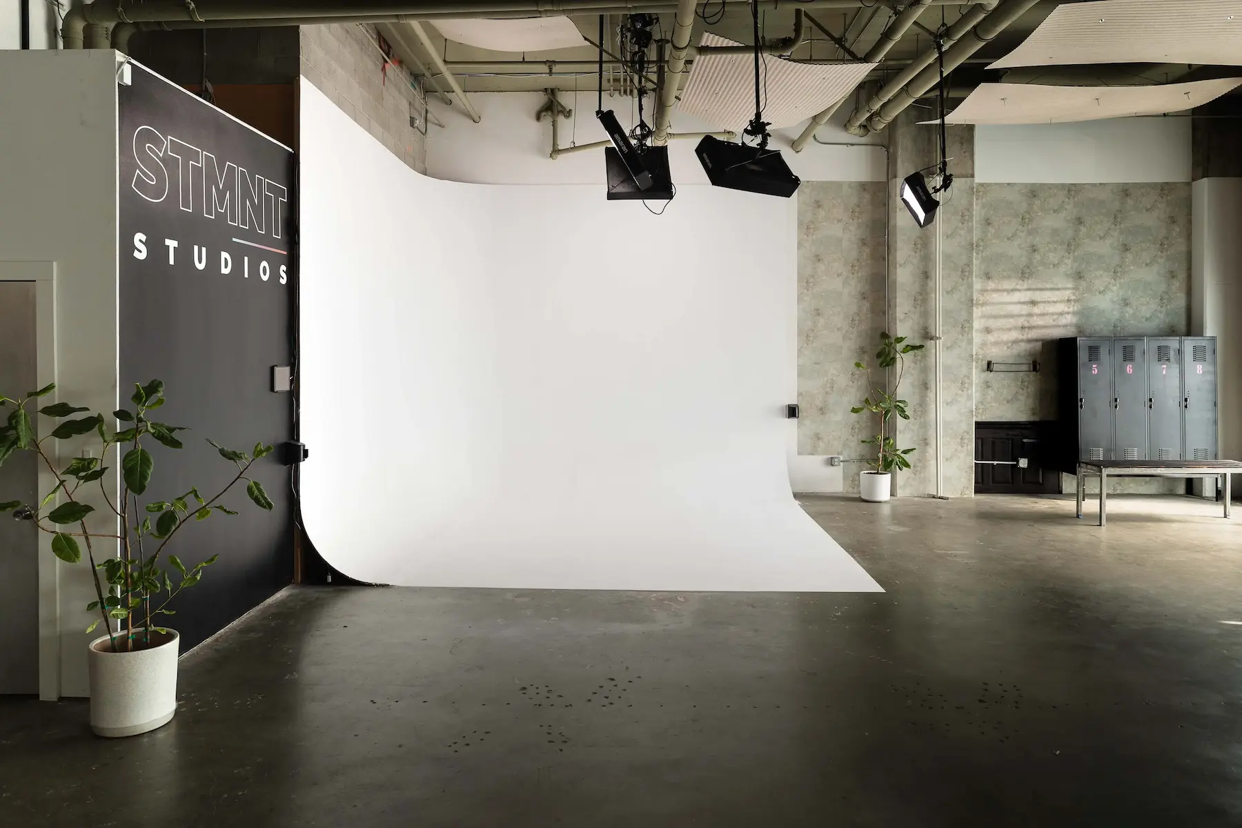 STMNT Studios 12x13 cyclorama wall with overhead lighting rigs in San Francisco production studio