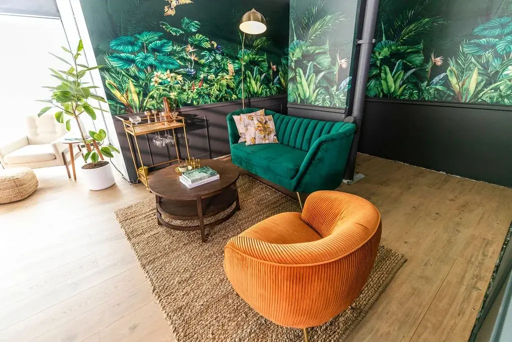 STMNT Studios lounge set with tropical jungle wallpaper and retro furniture