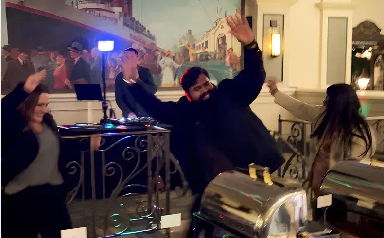 A group of people are dancing in a room.