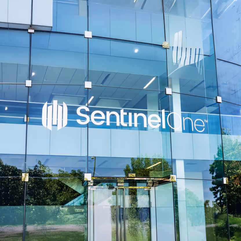 Glass building facade with SentinelOne company logo and entrance door.