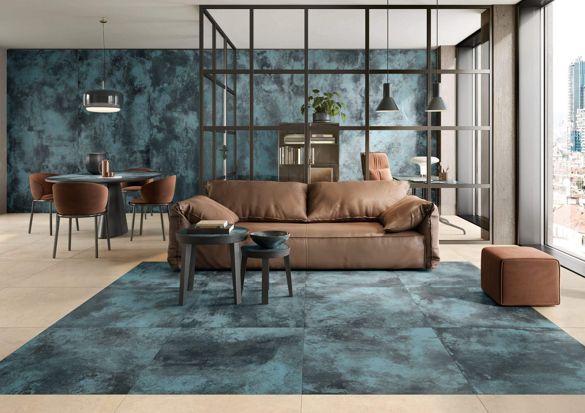 Modern living room with brown leather sofa, blue textured rug and wall, round dining table with four chairs, and glass office space with city view windows.