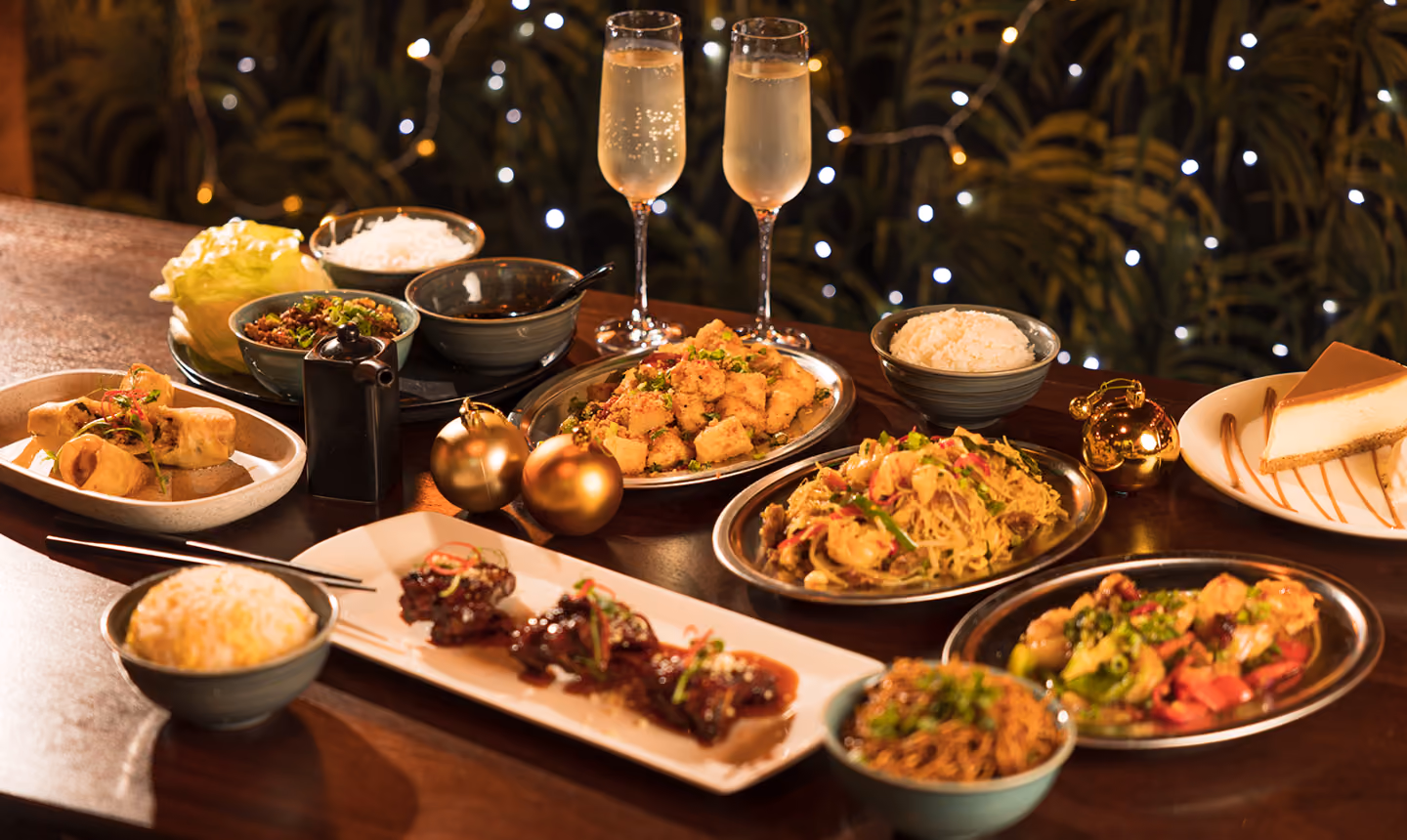 A festive table at Mama Yo with sharing plates and champagne
